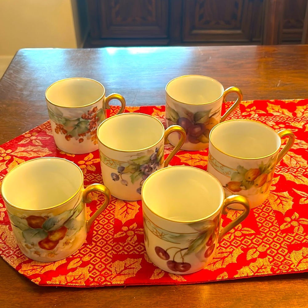 Six antique porcelain hand painted coffee mugs.